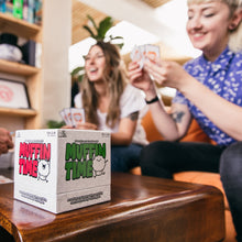 Load image into Gallery viewer, Two people playing a card game with 'Muffin Time' box on a table