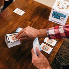 Load image into Gallery viewer, Two people playing a card game with 'Muffin Time' cards on a wooden table.