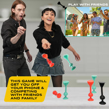 Load image into Gallery viewer, Two people playing a game with colorful silicon darts on a table, with an inset showing people playing outdoors.
