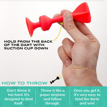 Load image into Gallery viewer, Hand holding a red silicon dart with instructions on how to throw it
