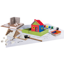 Load image into Gallery viewer, Colorful toy house set on a white surface with tools and materials.
