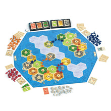 Load image into Gallery viewer, A board game setup arranged in a circle on a white background, featuring a large blue hexagonal playmat with numbered green, yellow, orange, and gray hex tiles, cards, tokens, and player pieces around it.
