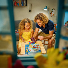 Load image into Gallery viewer, Dad and daughter playing building My First House at a table in a room.
