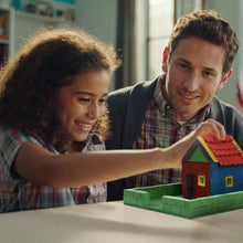 Load image into Gallery viewer, Man and young girl playing with a toy house in a room.
